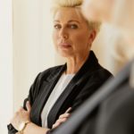 Sophisticated adult woman with short hair poses indoors with elegance and confidence.